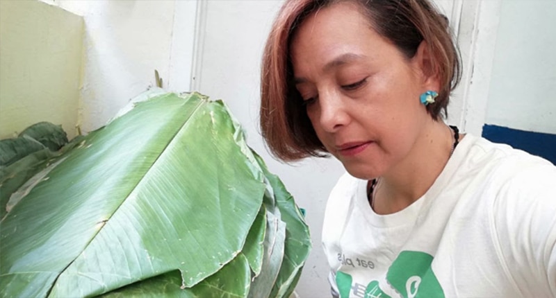 Dr. Diana Esguerra, WFPB.ORG's Reversive Medicine Director in Colombia prepares plantain leaves to use as compostable, ecological, and plant-based plates for 500 meals.